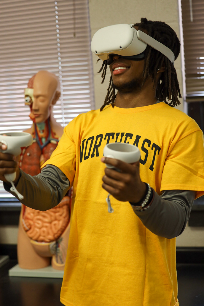student using VR goggles in Anatomy lab